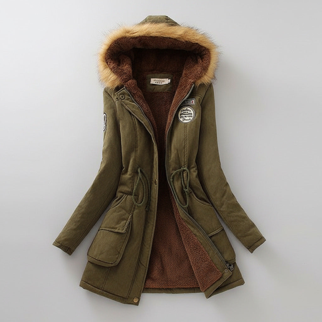 Green winter coat with fur hood on a light background