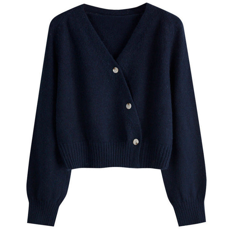 Navy blue cardigan with button details on a white background
