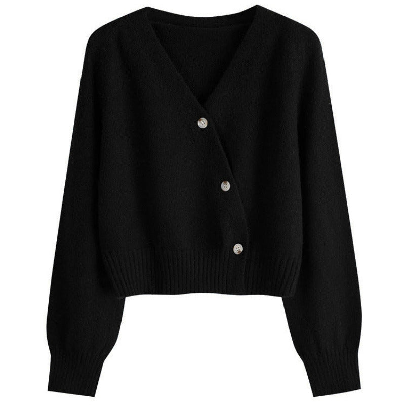 Black cardigan with silver buttons on a white background