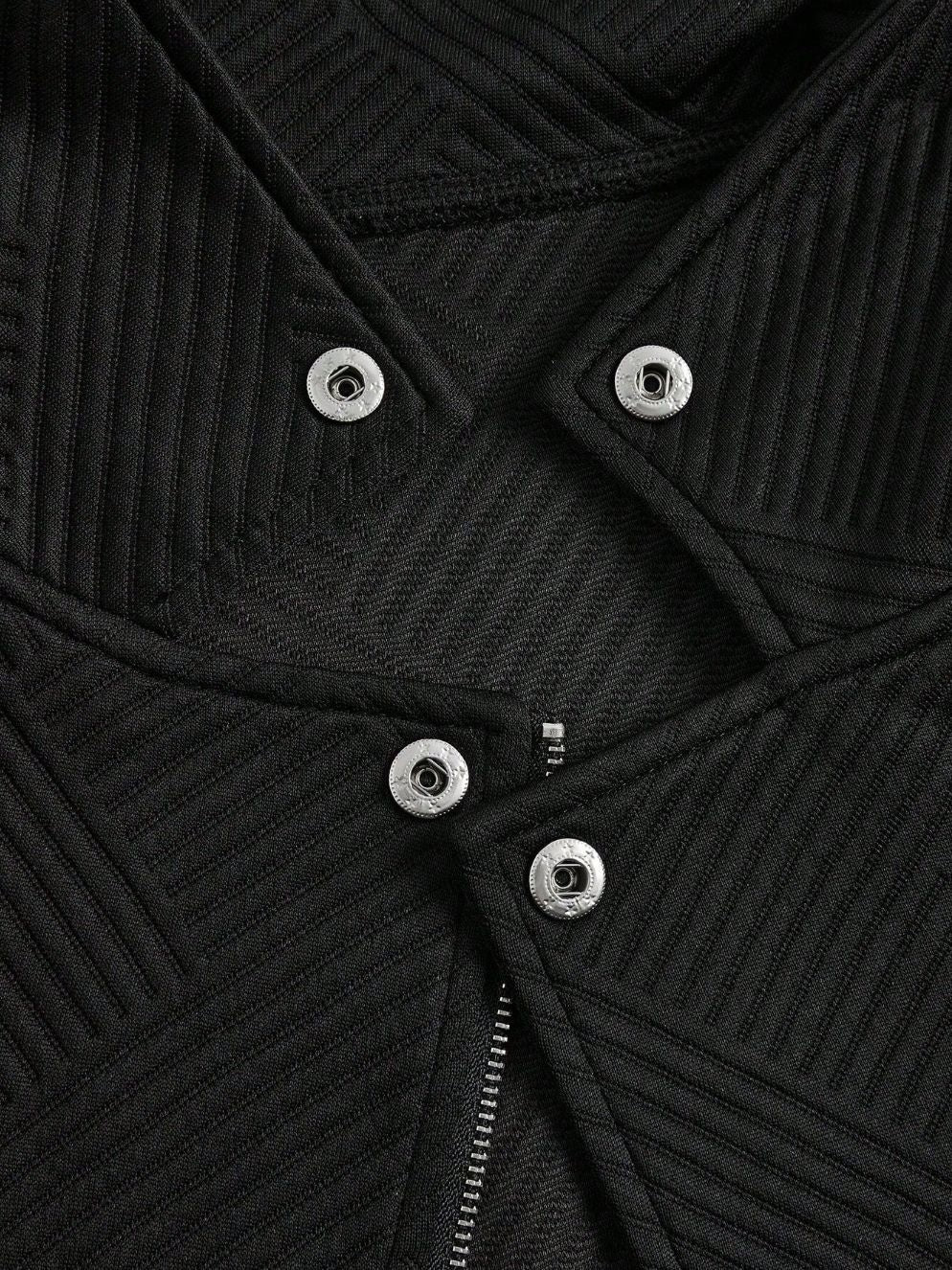 Close-up of a black ribbed sweater with button details