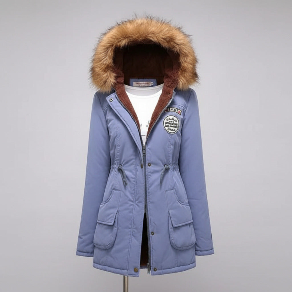 Blue winter coat with fur-lined hood on a beige background