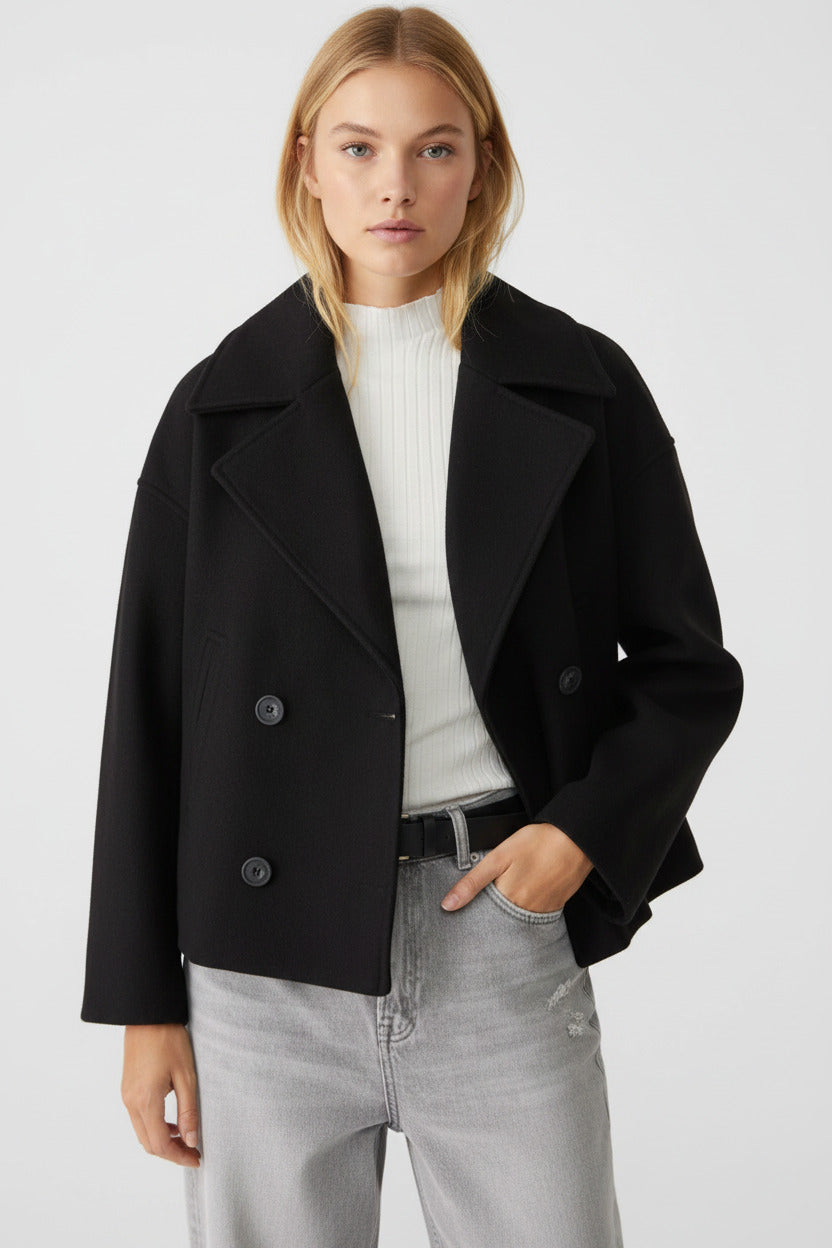 Person wearing a black coat on a white background
