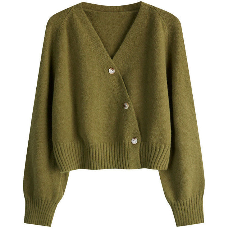 Green cardigan with buttons on a white background