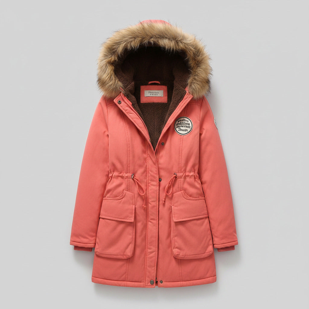 Pink coat with fur hood on a light beige surface
