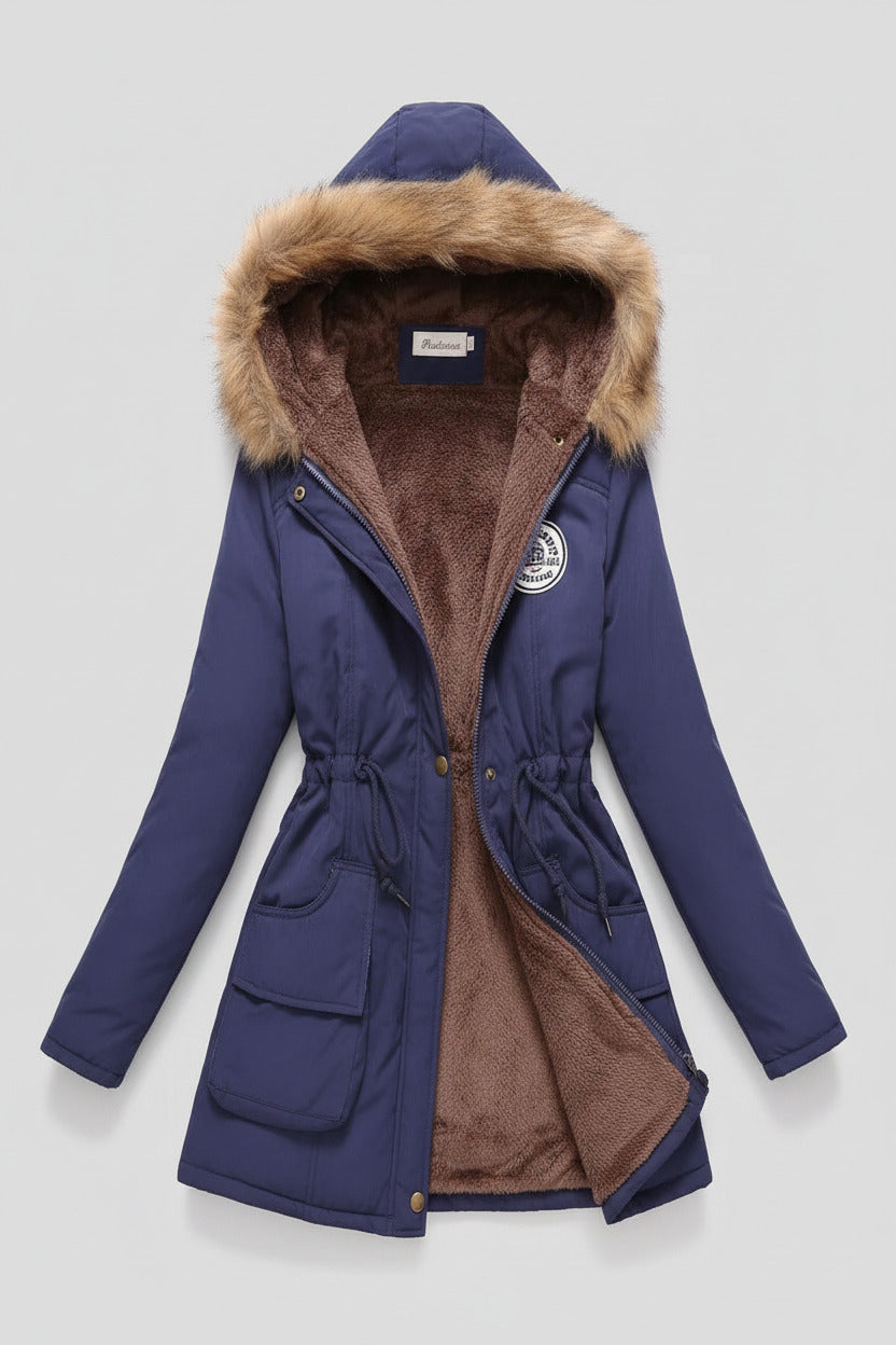 Blue winter coat with fur-lined hood on a beige background
